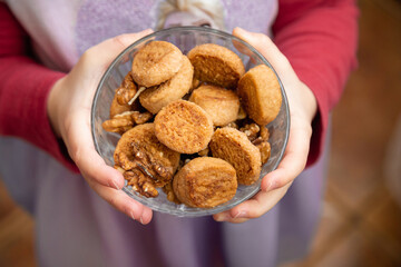 Children's hands hold a bowl of homemade cookies