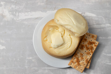 round portuguese cheese with cookies on white plate
