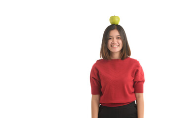Asian girl put the apple on his head and smile happily, on white background.