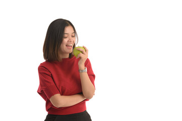Asian woman is holding an apple with her left hand and look interesting on white background.