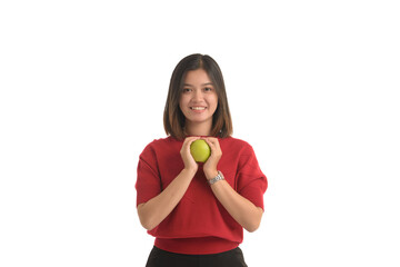 Asian woman is holding an apple with both hands attached to her chest, on white background.