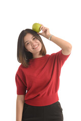 Asian woman is holding an apple with her left hand and look interesting on white background.