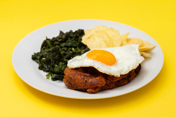 typical portuguese smoked sausage alheira with chips and greens