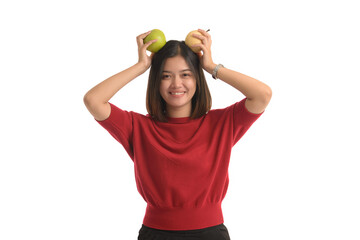 Asian girl put the apple on his head and smile happily, on white background.