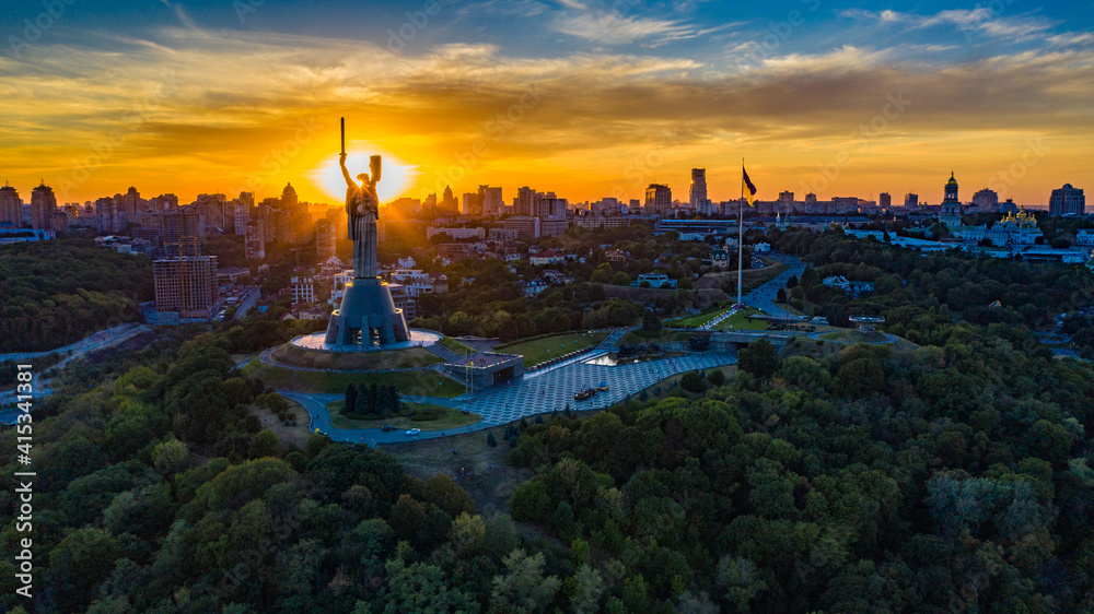 Wall mural aerial view to the motherland statue in the kiev while summer sunset. the well-known landmarks in ky