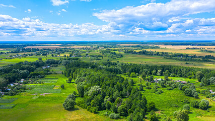 Fototapeta na wymiar Aerial view over beautiful suburb in wide valley, in the summer. Top view to the small village with a beautiful green landscape.