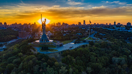 Aerial view to the Motherland statue in the Kiev while  summer sunset. The well-known landmarks in...