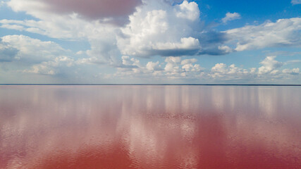 Amazing panoramic landscape of beautiful salt plains. pink lake. Bright red salt deposits in artificial salt evaporators, salt mining.