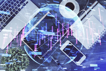 Double exposure of forex chart hologram over desktop with phone. Top view. Mobile trade platform concept.
