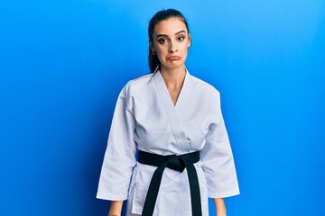 Beautiful brunette young woman wearing karate fighter uniform with black belt depressed and worry for distress, crying angry and afraid. sad expression. © Krakenimages.com