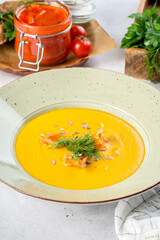 Carrot soup in a white plate filmed for the menu