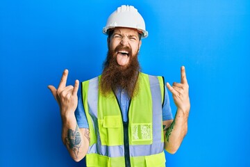 Redhead man with long beard wearing safety helmet and reflective jacket shouting with crazy...