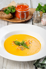 Carrot soup in a white plate filmed for the menu