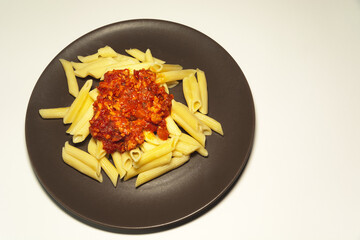 Meat with sauce and pasta on a plate