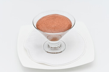 Chocolate mousse in a dessert bowl, on a white plate ready to serve, chocolate mousse