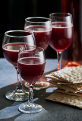 Jewish Matzah bread with four glasses wine. Passover holiday concept.