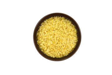 Millet flakes in a bowl isolated on white bacground.