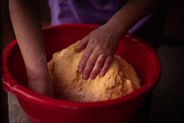housewife kneading the dough by hand. preparation of the recipe for traditional Romanian homemade cakes known as cozonac