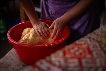 housewife kneading the dough by hand. preparation of the recipe for traditional Romanian homemade cakes known as cozonac