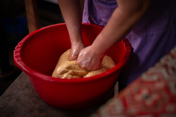 housewife kneading the dough by hand. preparation of the recipe for traditional Romanian homemade cakes known as cozonac