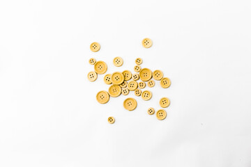 handful of wooden sewing buttons lying on white background