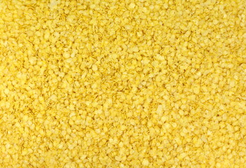 Yellow Millet flakes texture bacground.