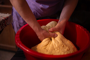 housewife kneading the dough by hand. preparation of the recipe for traditional Romanian homemade cakes known as cozonac