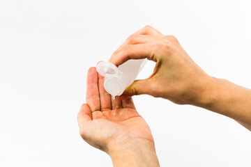 hands wiping with hydroalcoholic gel to avoid coronavirus infection on white background