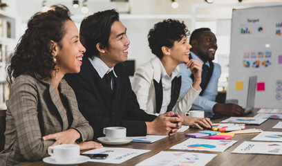 Business men and women of different nationalities were laughing, meeting happily and smiling. In the meeting room at the office. Concept happy meeting.