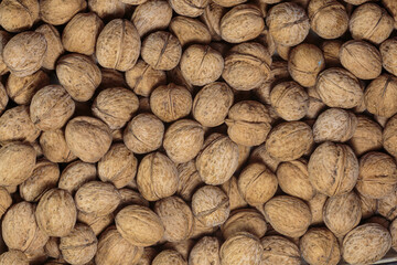 Walnut heap closeup. Vegan food. Concept of healthy food.