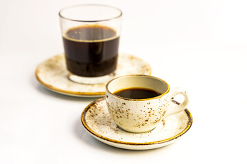 Morning coffee concept. Various coffe cup with saucer and glass on plate on white background. Copy space