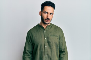 Obraz premium Young hispanic man wearing casual clothes depressed and worry for distress, crying angry and afraid. sad expression.