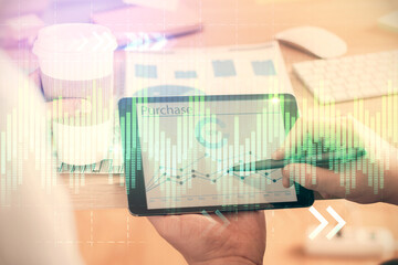 Double exposure of man's hands holding and using a phone and financial chart drawing. Market analysis concept.