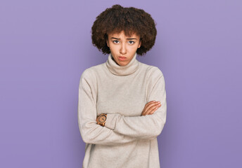 Fototapeta na wymiar Young hispanic girl wearing wool winter sweater skeptic and nervous, disapproving expression on face with crossed arms. negative person.