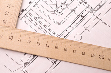 Architectural design, drawing paper and wooden ruler on a table close up
