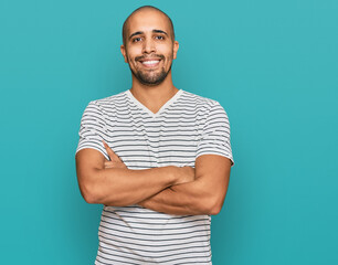 Hispanic adult man wearing casual clothes happy face smiling with crossed arms looking at the camera. positive person.