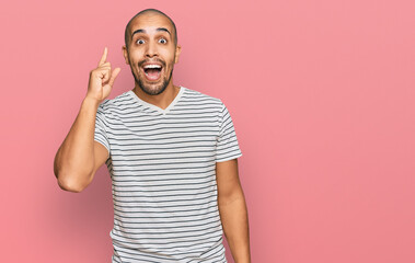Fototapeta premium Hispanic adult man wearing casual clothes pointing finger up with successful idea. exited and happy. number one.