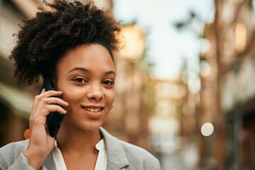 Young african american businesswoman smiling happy talking on the smartphone at the city.