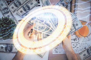 Multi exposure of blockchain theme drawing hologram and USA dollars bills and man hands. Business concept.