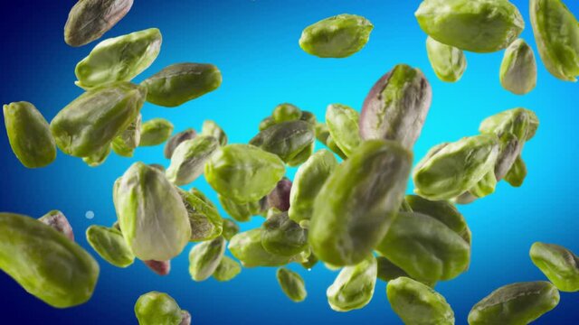 Flying of Peeled Pistachios in Blue Background