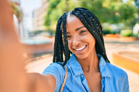 Young african american woman smiling happy making selfie by the camera at the park.