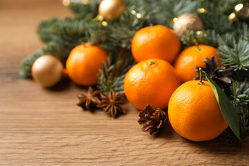 Christmas composition with tangerines on wooden table, closeup
