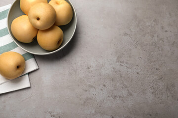 Fresh apple pears on grey table, flat lay. Space for text