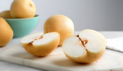 Naklejka na ściany i meble Cut and whole apple pears on table