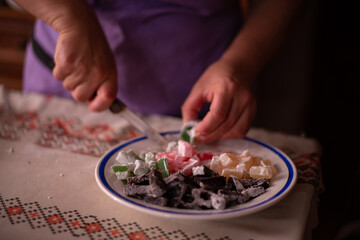housewife slicing Turkish delicacies into small cubes on a plate
