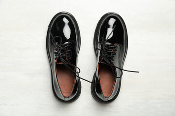 Pair of stylish female shoes on white wooden table, flat lay