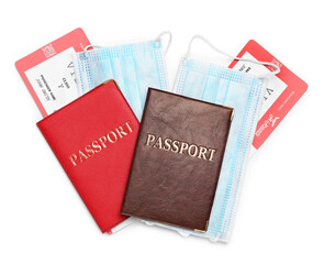 Passports, tickets and protective mask on white background, top view. Travel during quarantine