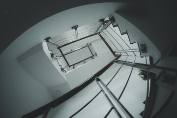 Perspective from bottom view of stairwell inside of home.
