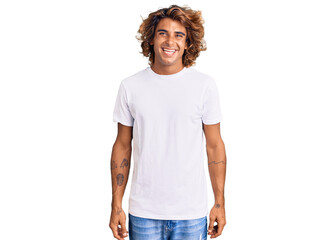 Young hispanic man wearing casual white tshirt with a happy and cool smile on face. lucky person.