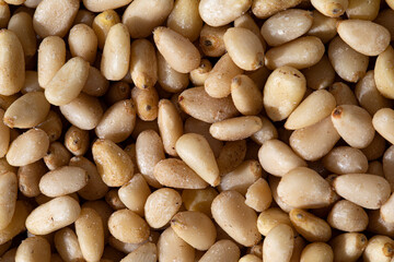 Full frame macro shot of ingredient raw pine nuts.